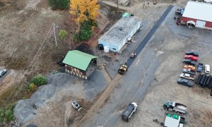 Aerial view of asphalt paving site preparation and grading work in Colonie, NY