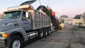 J. Hunziker Paving dump truck being loaded during asphalt milling job in the Capital Region
