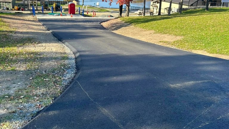 Freshly paved residential driveway with clean asphalt edges in Burnt Hills, NY by J. Hunziker Paving