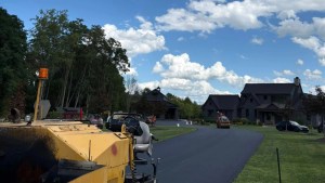 Paving equipment rolling fresh asphalt on a roadway project in New Lebanon, NY by J. Hunziker Paving